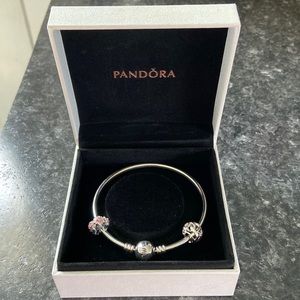 One in a million pandora bangle and two pandora charms.
